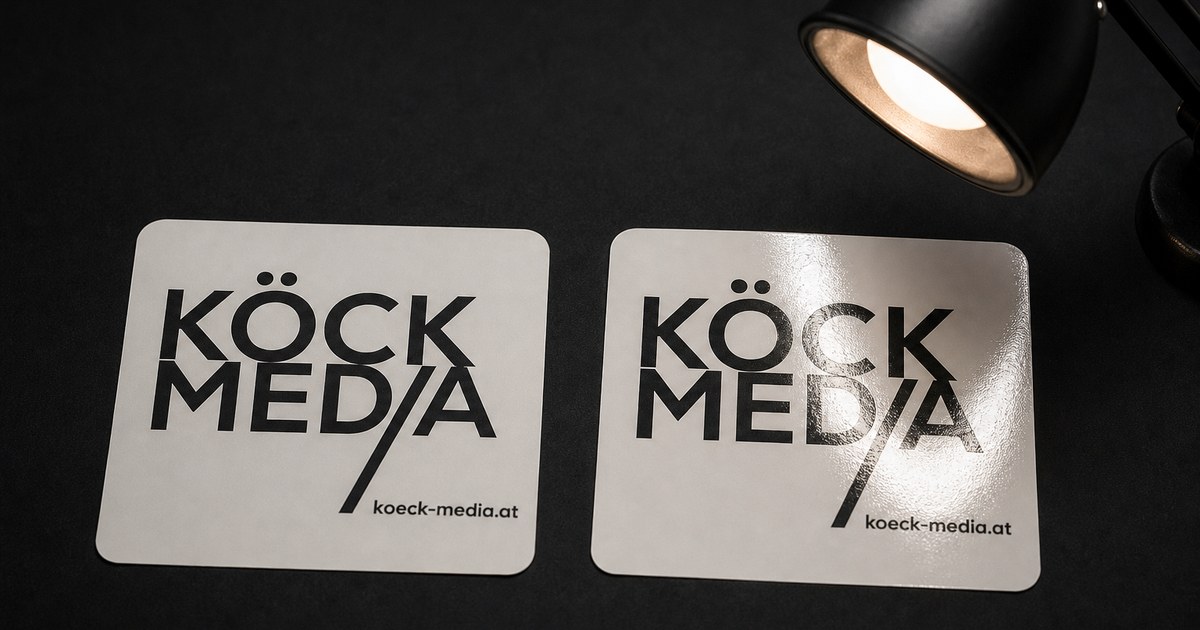 Two identical stickers under an angled lamp, one with a matte and one with a gloss laminate: only the gloss one shows a bright reflection