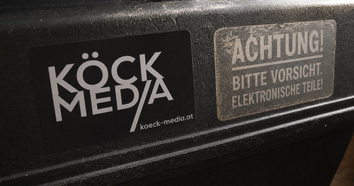 A new and a faded sticker with the same logo side by side on a toolbox